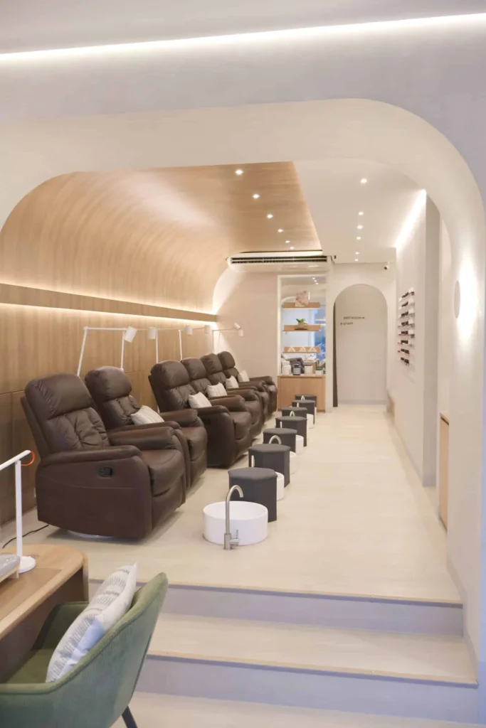 Relaxing nail salon with comfortable massage chairs and modern decor.