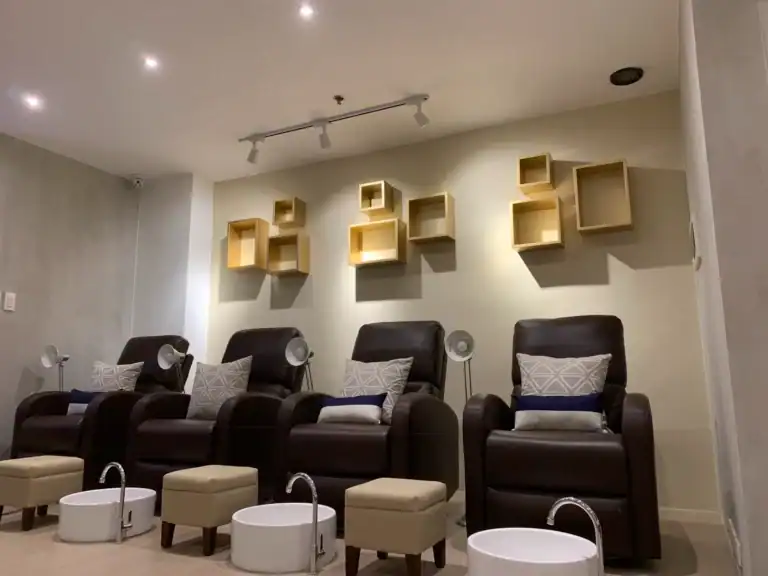 Relaxing nail spa chairs with foot baths at Ecru Nail Spa for pampering treatments.
