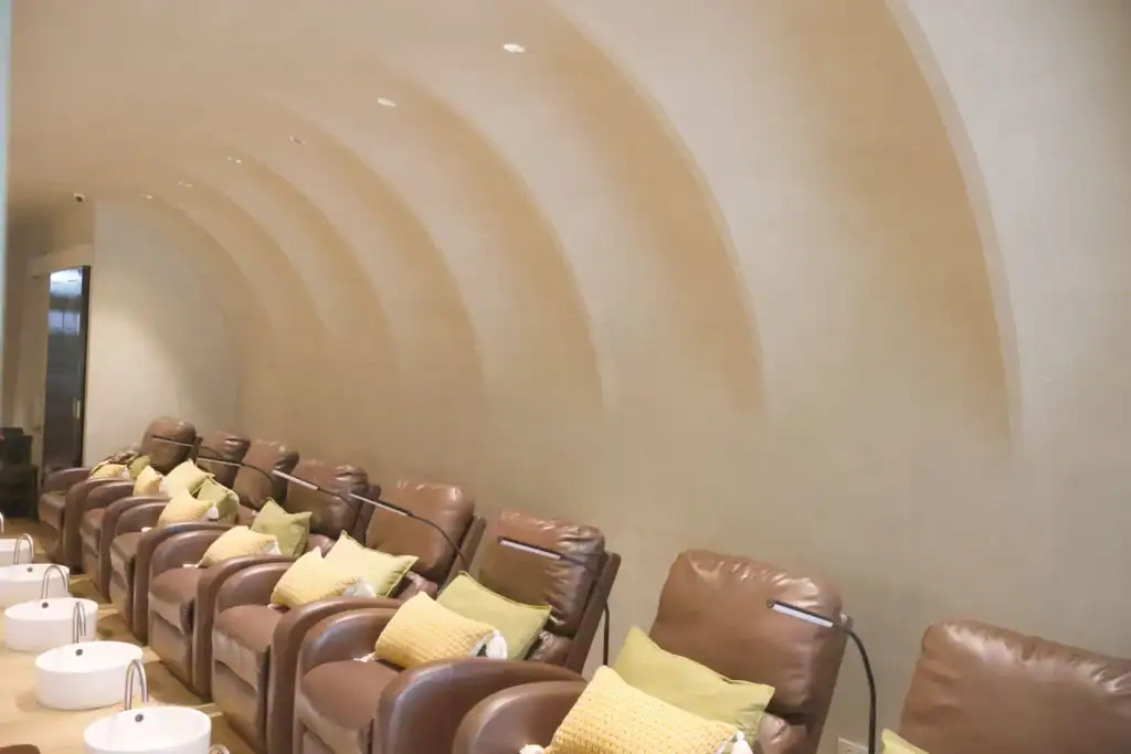 Relaxing nail spa lounge with comfortable chairs and soothing ambiance for a premium manicure experi.