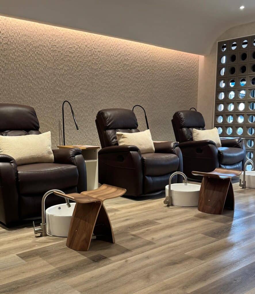 Luxury pedicure chairs with foot baths and comfortable pillows for a soothing experience.